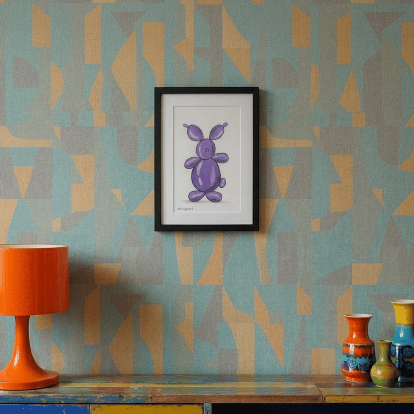Framed artwork of a purple rabbit on a wall with geometric pattern, orange lamp, and colorful vases.