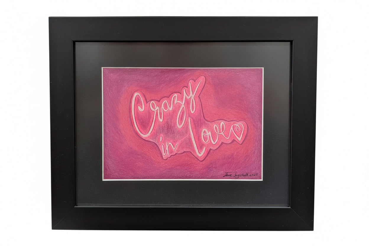 Framed artwork with 'Crazy in Love' text on a pink background